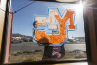 <p>Lauren Bengtzen, of Gilbertsville, Ky., paints the Marshall County High School logo on a window at a Taco John’s restaurant in Benton, Ky., Thursday, Jan. 25, 2018. Bengtzen, who graduated from Marshall County High School last spring, said she came in early for her shift at the restaurant to paint the window after the fatal school shooting Tuesday. (Photo: Ryan Hermens/The Paducah Sun via AP) </p>