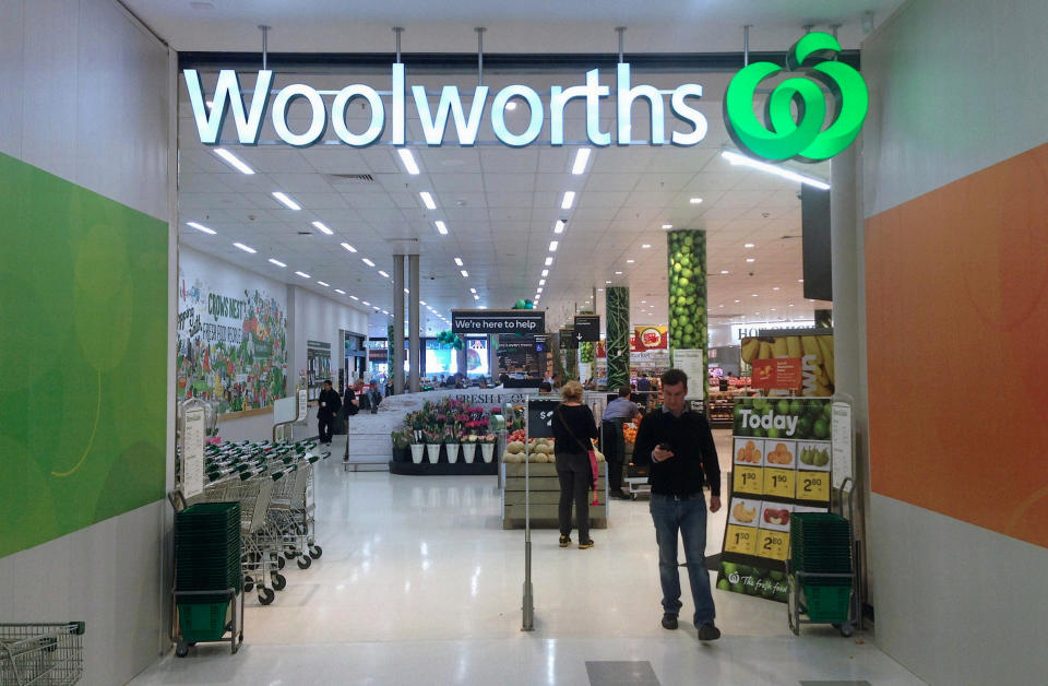 A customer walks out of a Woolworths store. Source: Reuters