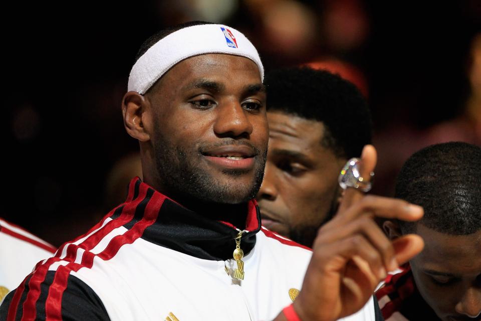 LeBron James #6 of the Miami Heat looks at his 2012 NBA Championship ring following a ceremony prior to the game against the Boston Celtics at American Airlines Arena on October 30, 2012 in Miami, Florida. (Photo by Chris Trotman/Getty Images)