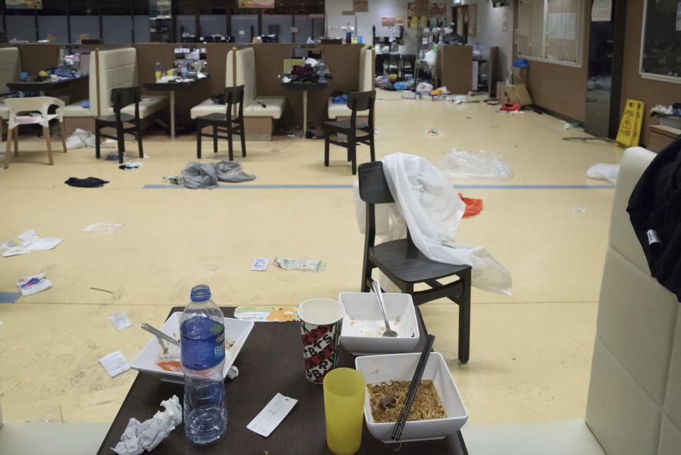 In this Friday, Nov. 22, 2019, photo, unfinished meals and debris are left at cafeteria at the Hong Kong Polytechnic University in Hong Kong. Most of the protesters who took over the university have left following clashes with police, but an unknown number have remained inside, hoping somehow to avoid arrest. (AP Photo/Vincent Thian)