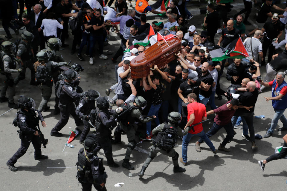 Israeli police confront mourners as they carry the casket of slain Al Jazeera veteran journalist Shireen Abu Akleh during her funeral in east Jerusalem, on May 13. Abu Akleh, a Palestinian-American reporter who covered the Mideast conflict for more than 25 years, was shot dead during an Israeli military raid in the West Bank town of Jenin.<span class="copyright">Maya Levin—AP</span>