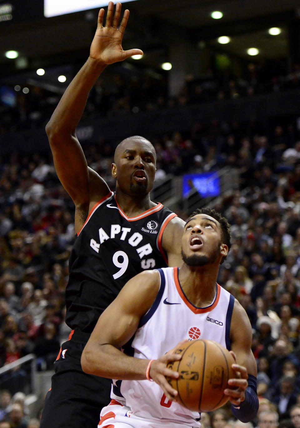 Washington Wizards guard Troy Brown Jr. (6) looks for a shot as Toronto Raptors forward Serge Ibaka (9) defends during the second half of an NBA basketball game Friday, Dec. 20, 2019, in Toronto. (Frank Gunn/The Canadian Press via AP)