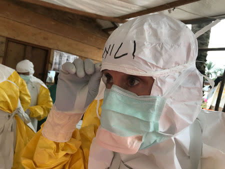 World Health Organisation's (WHO) Case Management Coordinator, Dr. William Fisher, checks his PPE as he prepares to administer Remdisivir to patients in Mangina, Democratic Republic of Congo August 28, 2018. WHO/Tarik Jasarevic/Handout via REUTERS