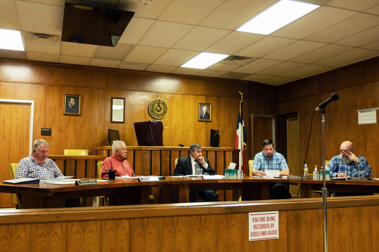 Loving County commissioners, including Ysidro Renteria, second from left, and County Judge Skeet Jones, center, listen to County Commissioner Raymond King read a resolution from the appraisal district's board of directors to remove Renteria on June 13. (Sarah M. Vasquez for NBC News)