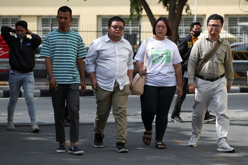 Protest leaders arrive to report themselves at a police station in Bangkok