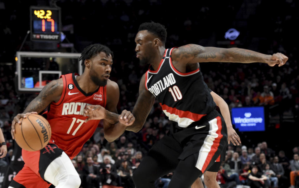 Houston Rockets forward Tari Eason, left, drives to the basket against Portland Trail Blazers forward Nassir Little, right, during the first half of an NBA basketball game in Portland, Ore., Sunday, Feb. 26, 2023. (AP Photo/Steve Dykes)