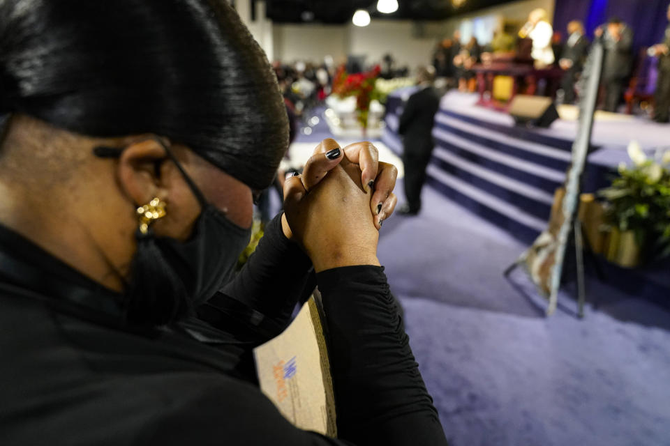 A mourner prays during funeral services for Daunte Wright at Shiloh Temple International Ministries in Minneapolis, Thursday, April 22, 2021. Wright, 20, was fatally shot by a Brooklyn Center, Minn., police officer during a traffic stop. (AP Photo/John Minchillo, Pool)