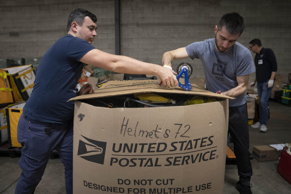 Volunteers with Razom for Ukraine, a New York-based nonprofit, pack firefighting and medical donations for shipment to Ukraine, Wednesday, Feb. 8, 2023, in Woodbridge Township, N.J. (AP Photo/John Minchillo)