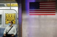 FILE PHOTO: A commuter wears a mask while riding the subway as cases of the infectious coronavirus Delta variant continue to rise in New York City, New York