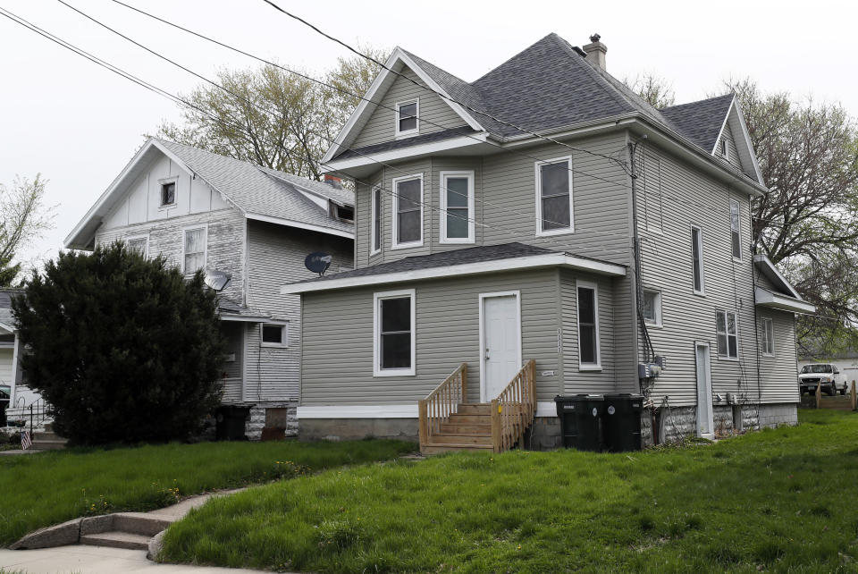 This Friday, May 1, 2020 photo shows a two-story duplex in Waterloo, Iowa, where two tenants died within days of each other from COVID-19. The coronavirus spread from the nation’s meatpacking plants to the broader communities where many of their employees live. (AP Photo/Charlie Neibergall)