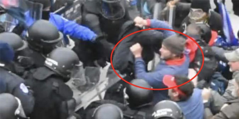 A screenshot from footage, shot from above, of police attempting to halt rioters outside the Capitol. The man who FBI believes is Landon Copeland is circled.