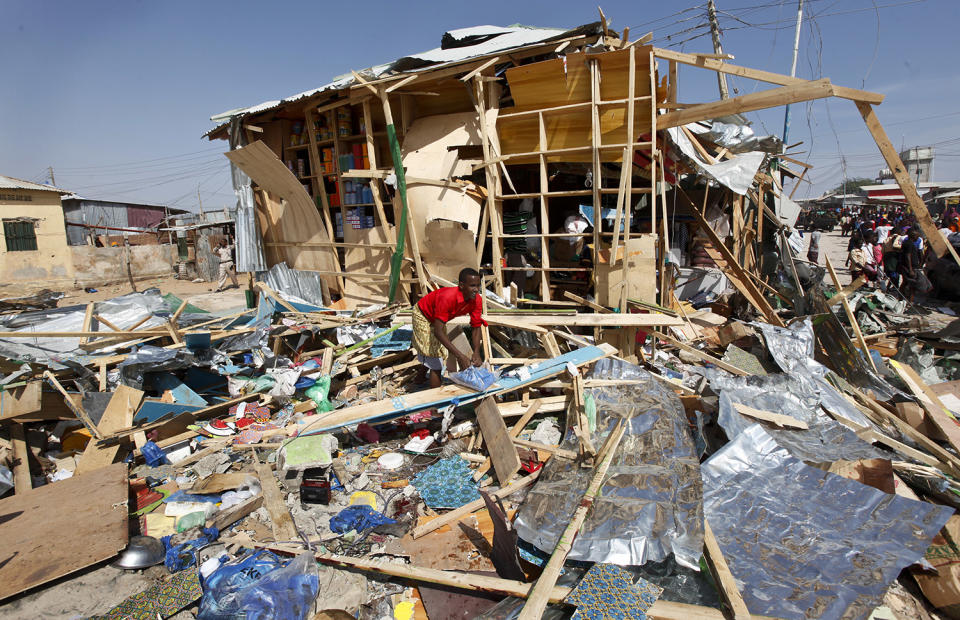 <p>A shopkeeper surveys the wreckage of shops destroyed by a blast in a market in the capital Mogadishu, Somalia, Feb. 19, 2017. A Somali police officer says a blast at a busy market in the western part of Somalia’s capital tore through shops and food stands and killed more than a dozen people and wounded many others. (Photo: Farah Abdi Warsameh/AP) </p>