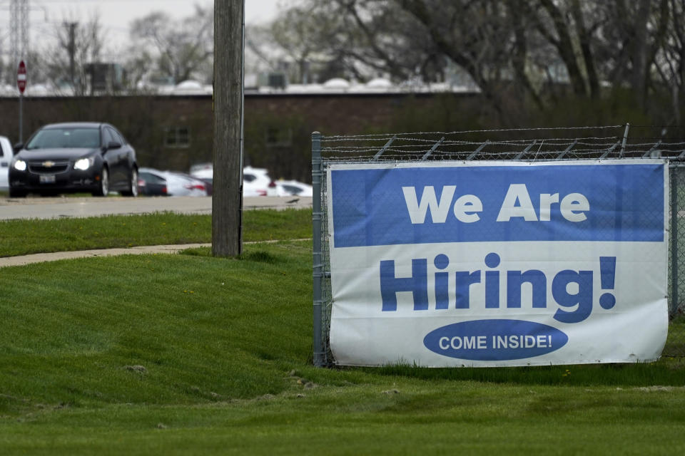 A hiring sign is displayed in Wheeling, Ill., Thursday, May 5, 2022. America’s employers added 428,000 jobs in April, extending a streak of solid hiring that has defied punishing inflation, chronic supply shortages, the Russian war against Ukraine and much higher borrowing costs. (AP Photo/Nam Y. Huh)