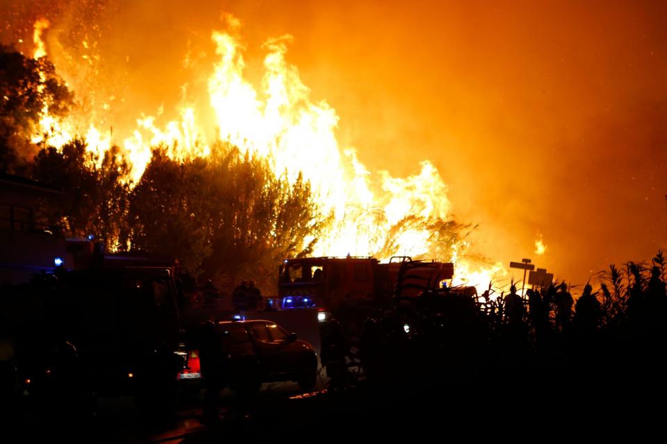 Huge flames: Firefighters work to put out a fire in Biguglia, Corsica: AFP/Getty Images