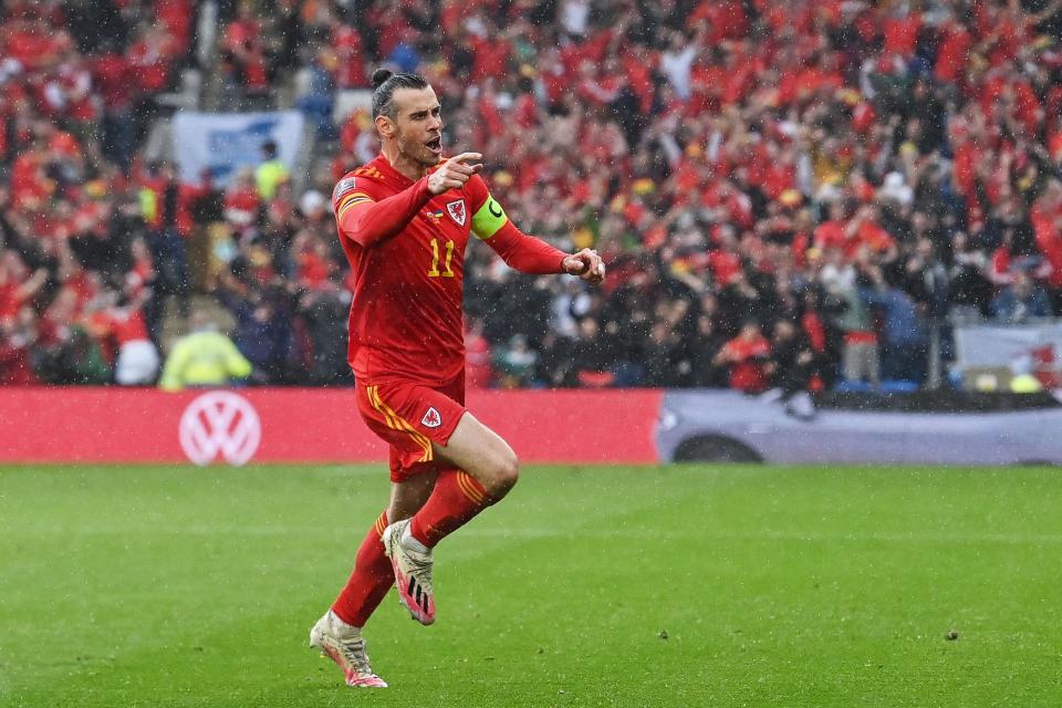 Gareth Bale celebrates after his free-kick is diverted home (AFP via Getty Images)