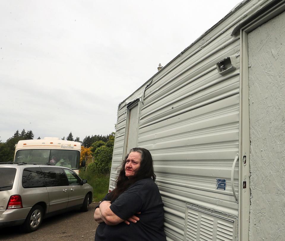 Georgina Gariepy stands outside her travel trailer parked in the county public works' property just off Poplars Avenue NW, near the Haselwood YMCA in Silverdale on Thursday.