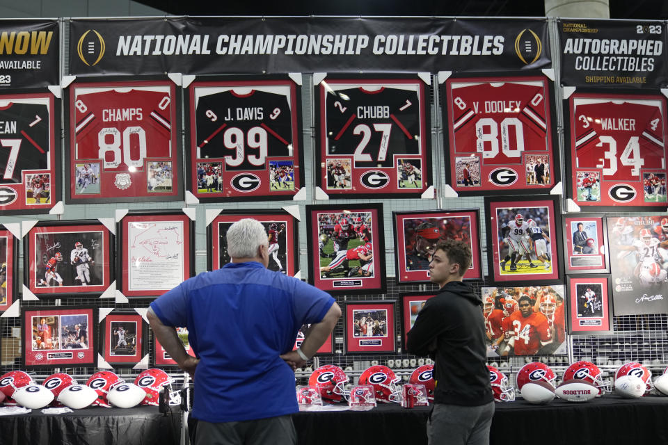 Memorabilia is displayed at a fan fest at the Los Angeles Convention Center, Thursday, Jan. 5, 2023, in Los Angeles. Georgia is scheduled to face TCU, Monday for the CFP national football championship in Inglewood, Calif. (AP Photo/Marcio Jose Sanchez)
