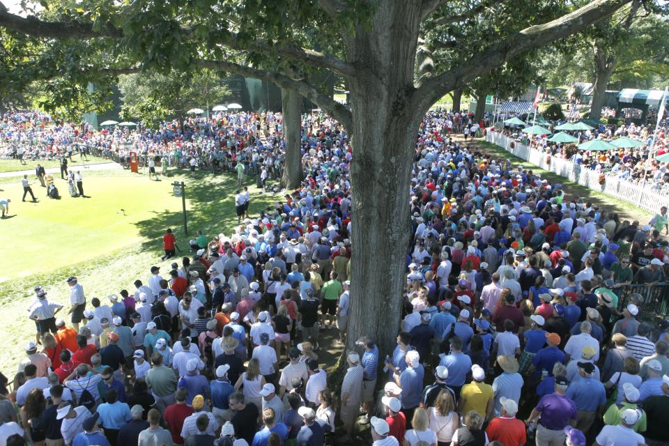 Crowds gather at the first and 14th tees during the third round of the 95th PGA Championship at Oak Hill Country Club  on Aug. 10, 2013.