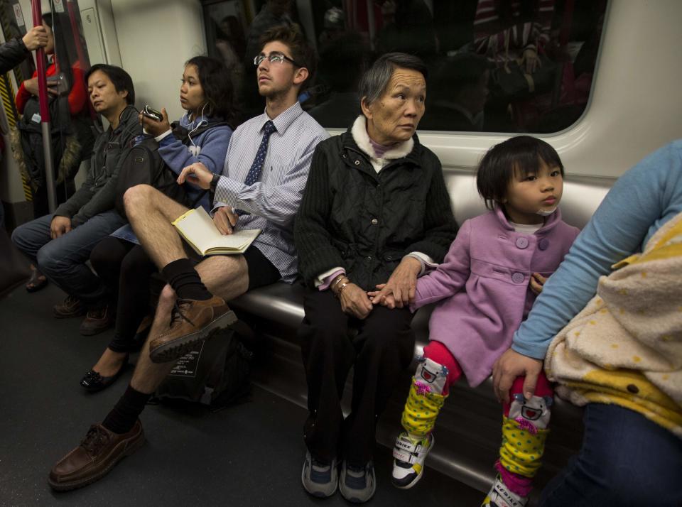 A man takes part in the annual "No Pants Subway Ride" on a Mass Transit Railway (MTR) train in Hong Kong