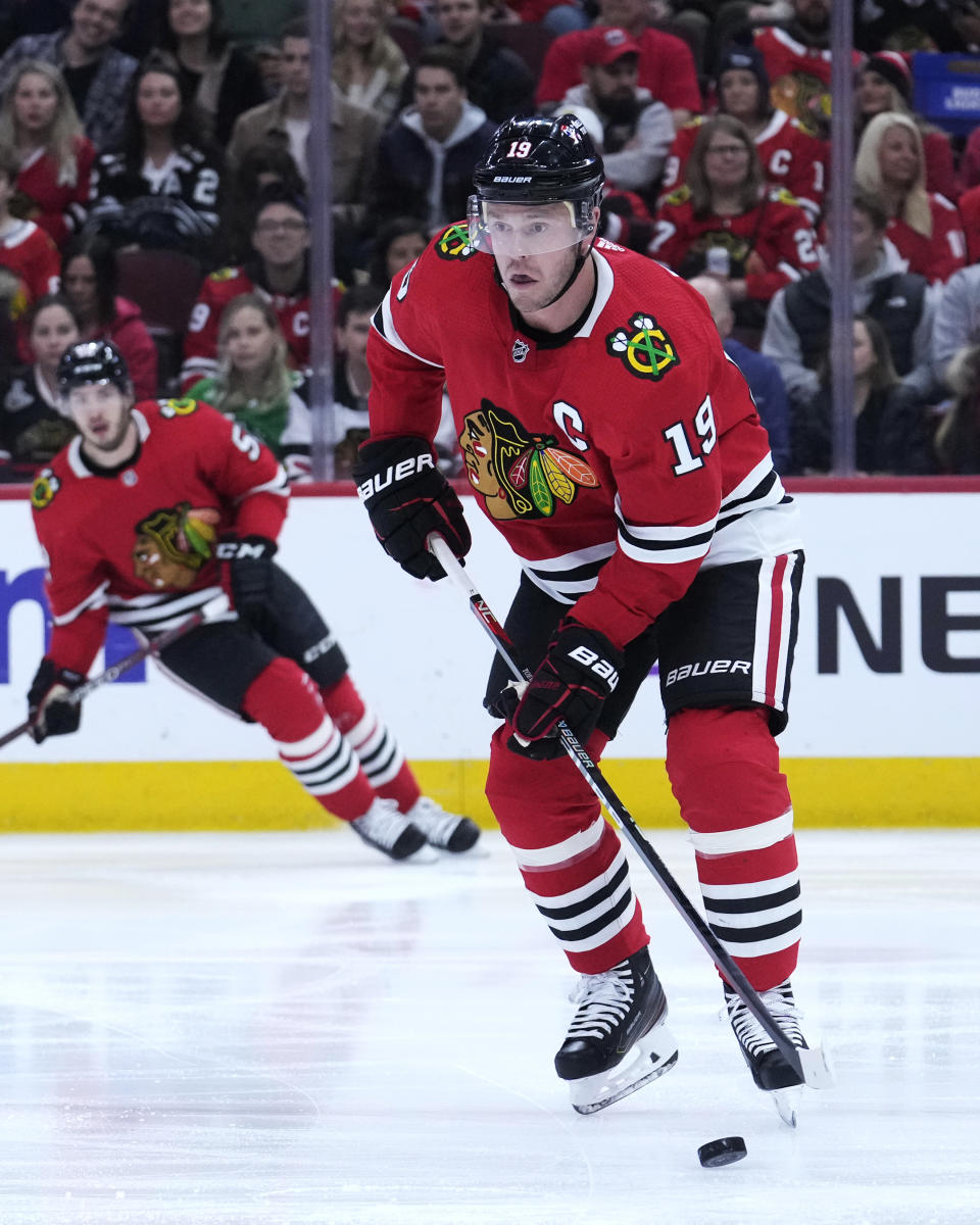 Chicago Blackhawks' Jonathan Toews handles the puck during the first period of the team's NHL hockey game against the New Jersey Devils on Saturday, April 1, 2023, in Chicago. Toews returned to the ice from a two-month medical leave of absence. (AP Photo/Charles Rex Arbogast)