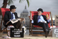  EDITORIAL USE ONLYLuke Harman (left) and Mark Webber, dressed as bankers, sit on The Isle of Shady, a pop-up tax haven set up by Enough Food for Everyone IF campaigners, sits on the South Bank of the river Thames at Gabriel's Wharf in London ahead of the Open for Growth: Tax, Trade and Transparency event on 15th June and the G8 summit. PRESS ASSOCIATION Picture date: Friday June 14, 2013. Enough Food for Everyone IF is a coalition of more than 200 organisations working together to ensure that governments tackle causes of the global hunger crisis in the year that the UK Government hosts the G8 leaders. Photo credit should read: David Parry/PA Wire 