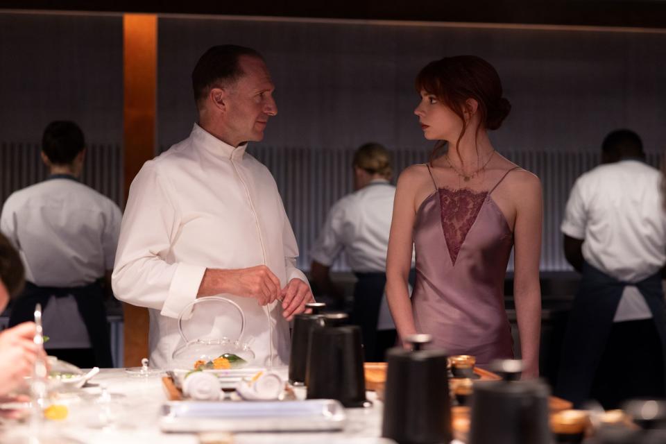 Still from "The Menu," a Searchlight Pictures film starring Anya Taylor-Joy (right), whose character is from Brockton. Here she speaks to Ralph Fiennes, who plays Chef Julian Slowik.