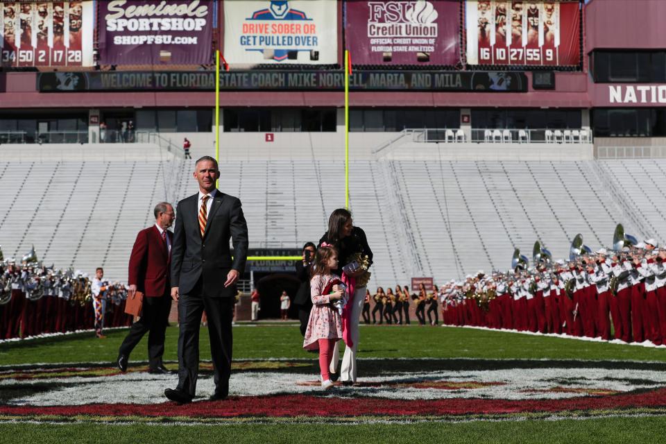 Newly hired Florida State University Head Football Coach Mike Norvell walks across Bobby Bowden Field at Doak Campbell Stadium on his way to a press conference in the Champions Club where he will be introduced to the public Sunday, Dec. 8, 2019. 