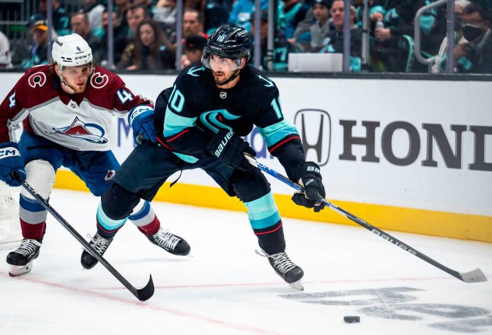 Seattle Kraken center Matty Beniers (10) looks to pass the puck as Colorado Avalanche defenseman Bowen Byram (4) defends during the third period of a first round 2023 Stanley Cup Playoffs game against the Colorado Avalanches at Climate Pledge Arena in Seattle on Saturday, April 22, 2023. The Seattle Kraken lost 4-6 to the Colorado Avalanches.