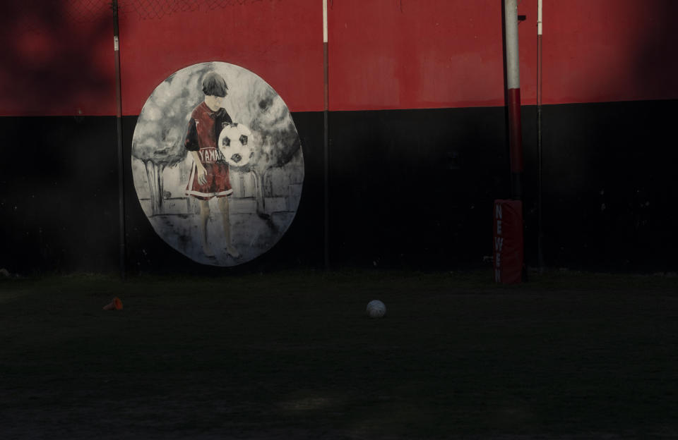 A painting of Lionel Messi depicting his days at a football school at Newell's All Boys club, where played as a kid in Rosario, Argentina, is seen Wednesday, Dec.14, 2022. (AP Photo/Rodrigo Abd)