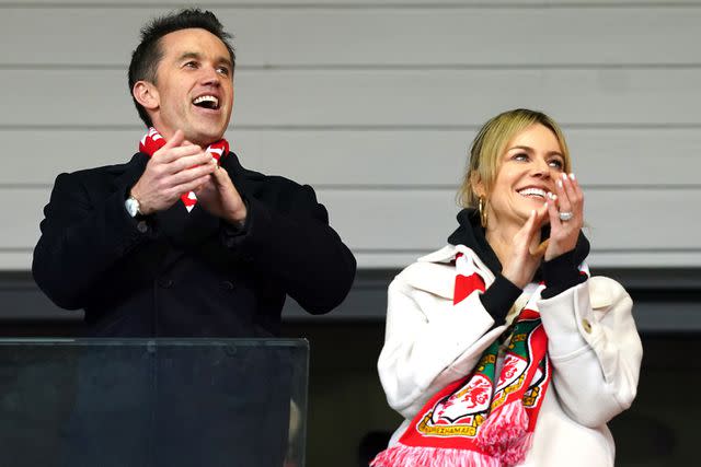 <p>Martin Rickett/PA Images via Getty</p> Rob McElhenney and Kaitlin Olson at a Wrexham match in April 2023