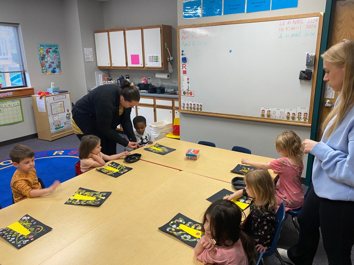 Students in the moyenne class of 3- and 4-year-old student at La Petite Ecole on Wednesday work on their versions of Gustav Klimt's Tree of Life, overseen by teachers Rose Cummings and Allison Ortmann. Moyenne is medium-sized.