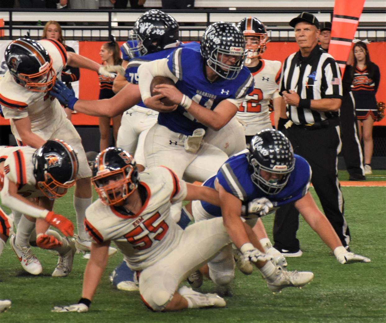 Whitesboro quarterback Kyke Meier runs through a crowd of East Syracuse-Minoa defenders during the second half of Section III's Class A championship game Saturday.