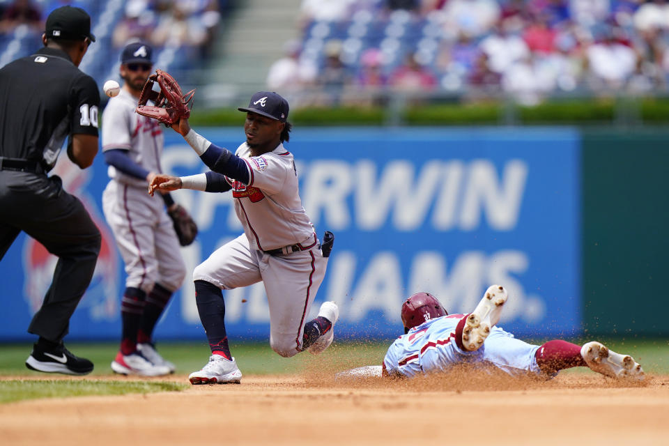 Philadelphia Phillies' Odubel Herrera, right, steals second base past Atlanta Braves second baseman Ozzie Albies during the first inning of a baseball game, Thursday, June 10, 2021, in Philadelphia. (AP Photo/Matt Slocum)