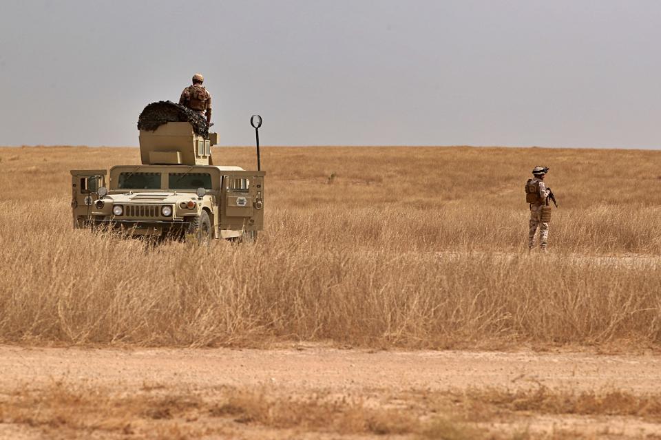 Iraqi security forces secure the Iraq-Syria border around the Rabiaa border crossing, Iraq, Wednesday, Oct. 16, 2019. Najah al-Shammari, Iraq's defense minister said that some members of the Islamic State group were able to flee northern Syria and cross into Iraq. The Iraqi official added that some of them are still at large while others were detained. (AP Photo/Hadi Mizban)