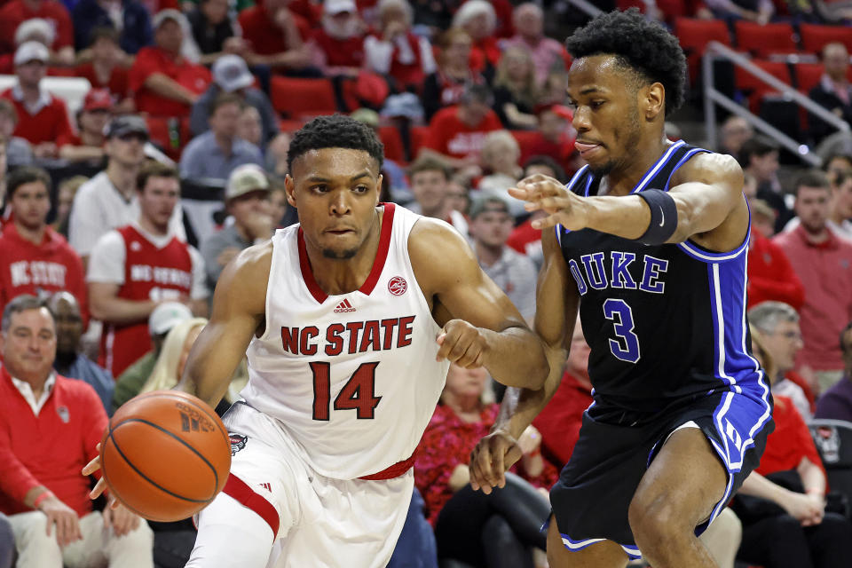 North Carolina State's Casey Morsell (14) drives the ball around Duke's Jeremy Roach (3) during the second half of an NCAA college basketball game in Raleigh, N.C., Monday, March 4, 2024. (AP Photo/Karl B DeBlaker)