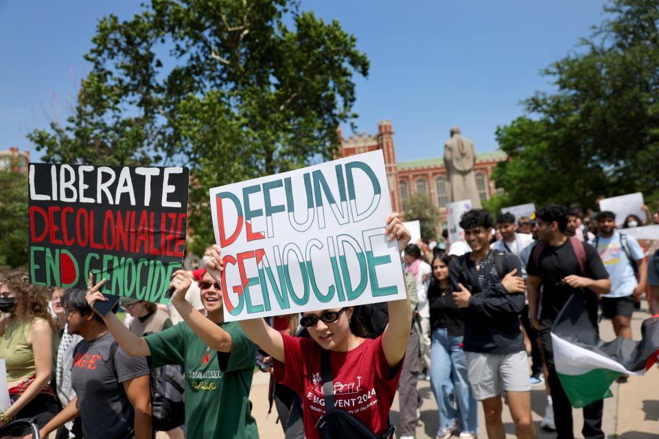 People hold signs in support of Palestine as they march Wednesday on the University of Oklahoma's Norman campus during a May Day rally hosted by the University of Oklahoma's Student Coalition for Palestinian Liberation and Student Socialist League.