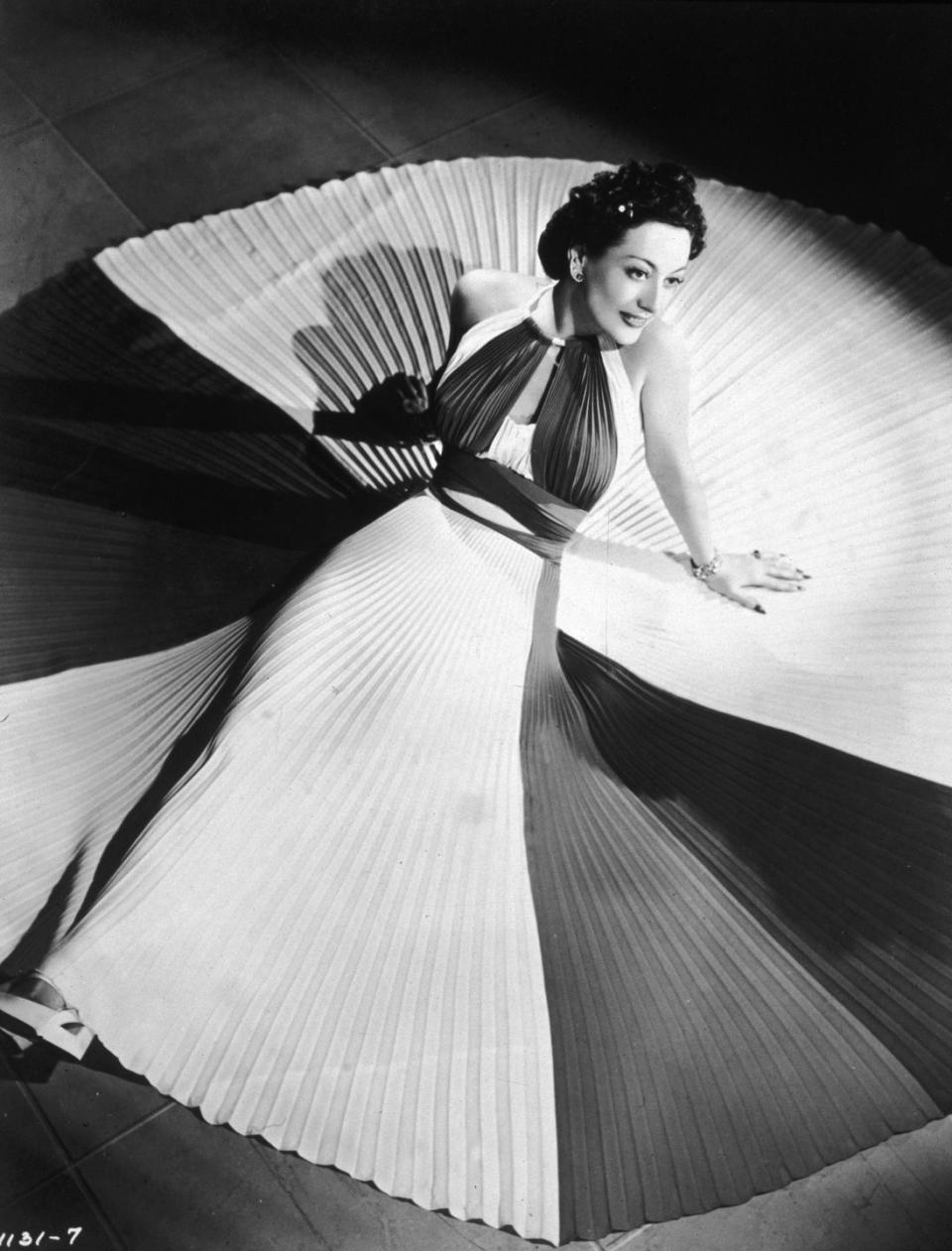 1940: Modeling a pleated evening gown