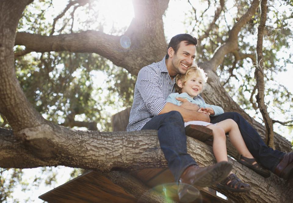 summer activities father and son hugging in tree