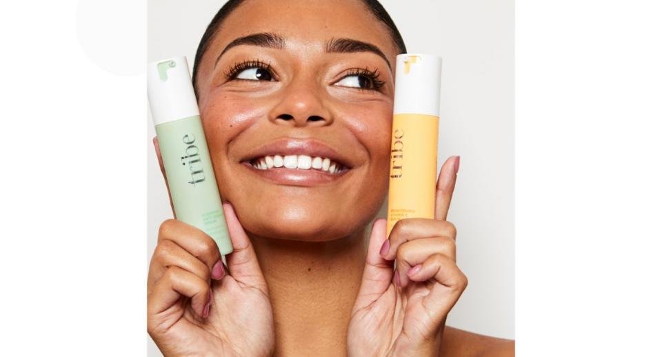 Woman with Tribe skincare products