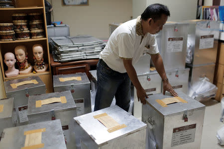 An election official prepares ballot boxes before distributing them to polling stations, in Jakarta, Indonesia April 18, 2017. REUTERS/Beawiharta