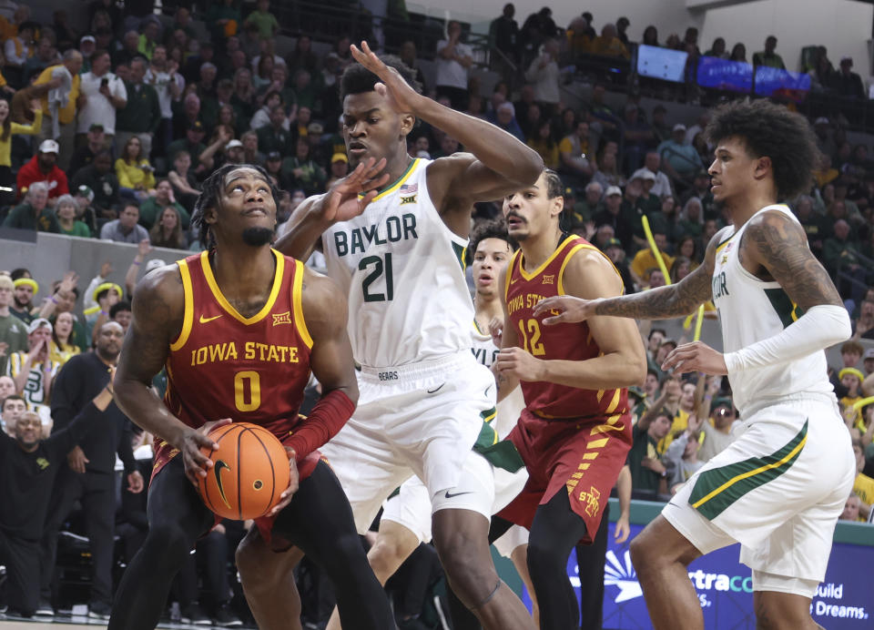 Iowa State forward Tre King looks at the basket while defended by Baylor center Yves Missi (21) and Jalen Bridges, right, in the first half of an NCAA college basketball game, Saturday, Feb. 3, 2024, in Waco, Texas. (AP Photo/Rod Aydelotte)