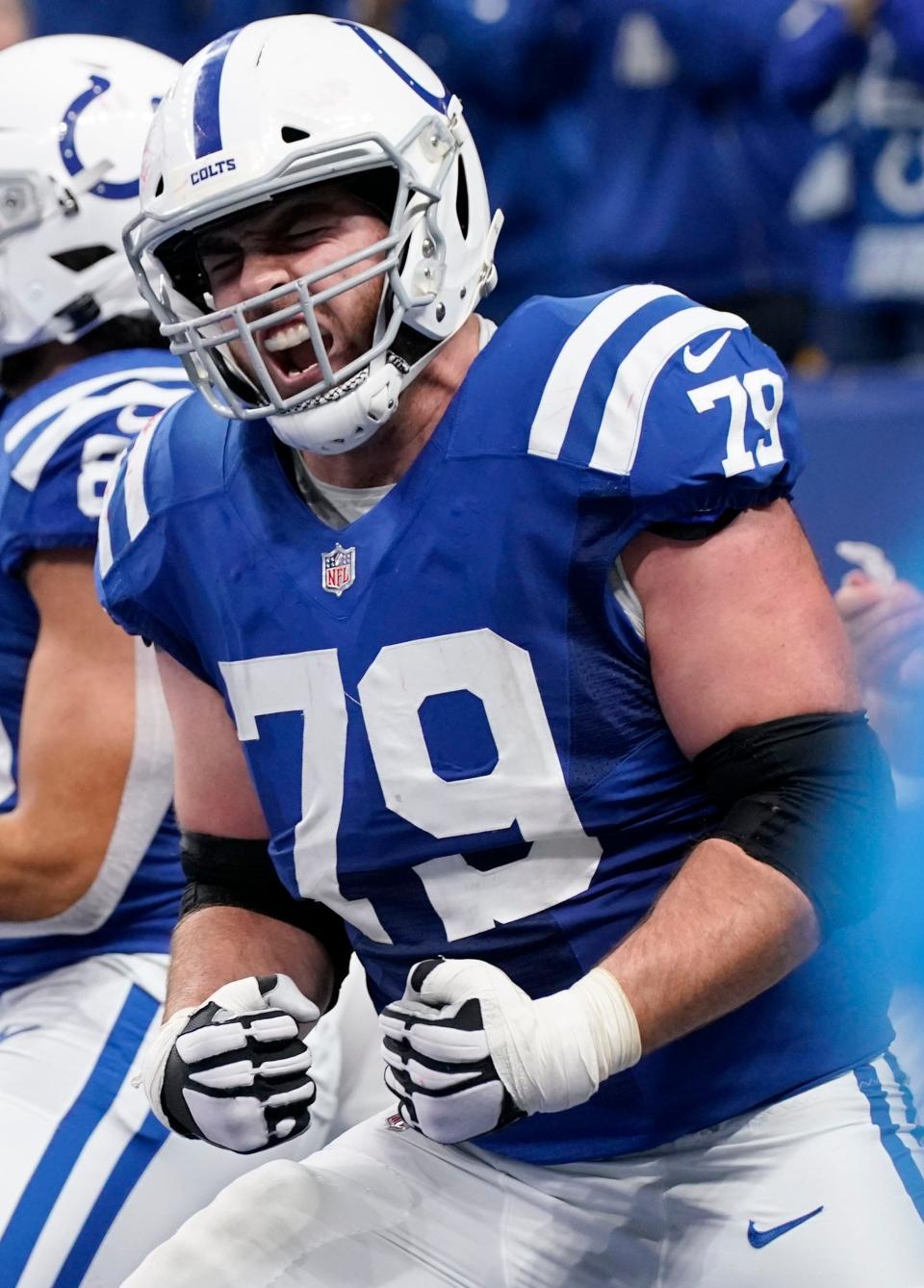 Indianapolis Colts offensive tackle Eric Fisher (79) celebrates after a touchdown by Indianapolis Colts running back Jonathan Taylor (28) on Saturday, Dec. 18, 2021, during a game against the New England Patriots at Lucas Oil Stadium in Indianapolis.