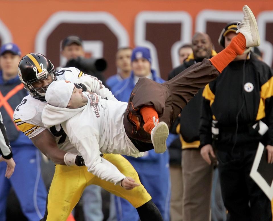 Pittsburgh Steelers linebacker James Harrison slams Browns fan Nathan Mallett to the turf after he ran onto the field on Dec. 24, 2005, in Cleveland.