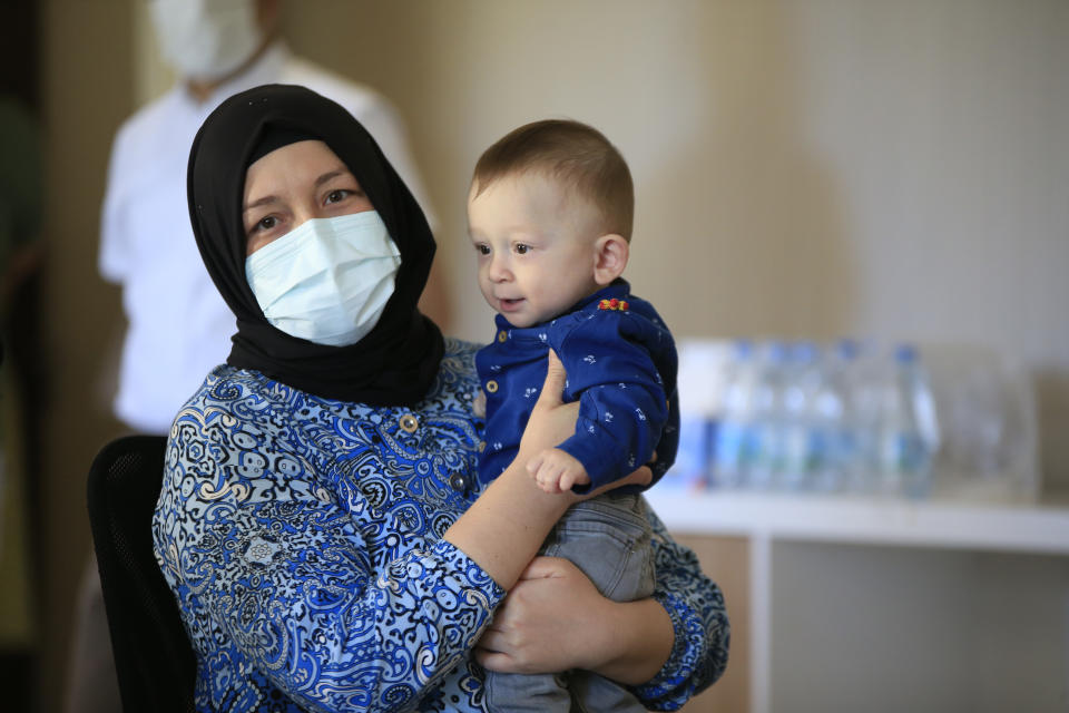 Derya Sert (L) who became the worldâs first uterus recipient is seen with her baby, 15 months old Omer Ozkan who was named after one of the caring doctors at Turkey's Akdeniz University Hospital in Antalya, on September 24, 2021.