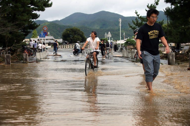 Muddy water is flooded from the Katsura river in Kyoto as torrential rain hit western Japan, on September 16, 2013