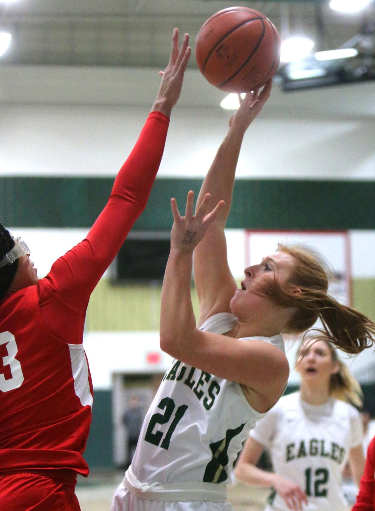 Keely Burke, 21, of GlenOak takes a shot while being guarded by Hana Belibi, left, of Regis Jesuit during their game at GlenOak on Friday..