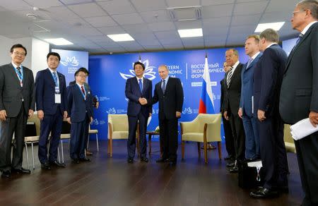 Russian President Vladimir Putin (R) shakes hands with Japanese Prime Minister Shinzo Abe during a meeting on the sidelines of Eastern Economic Forum in Vladivostok, Russia, September 2, 2016. Sputnik/Kremlin/Alexei Druzhinin/via REUTERS