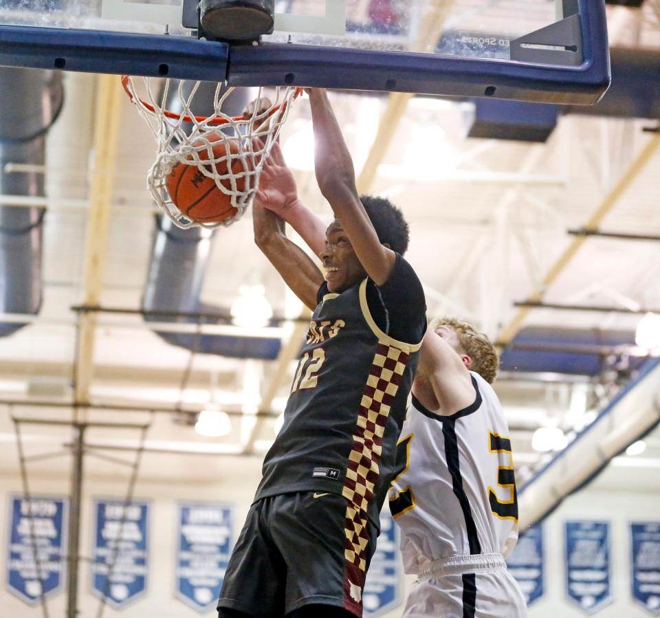 Brandywine senior Ja'Torian Smith dunks the ball while Covenant Christian junior Ben Elzinga tried to block it during an MHSAA Division 3 boys basketball state quarterfinal game Tuesday, March 12, 2024, at Loy Norrix High School in Kalamazoo.