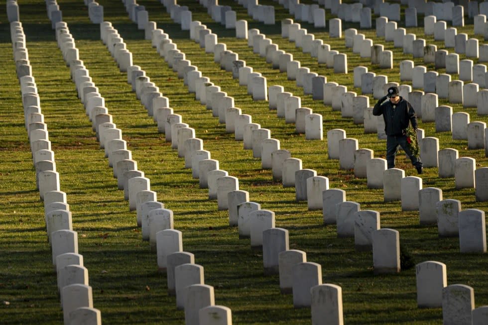 A man salutes after placing a wreath at Arlington National Cemetery, Saturday, Dec. 16, 2023, in Arlington, Va. (AP Photo/Nathan Howard, File)