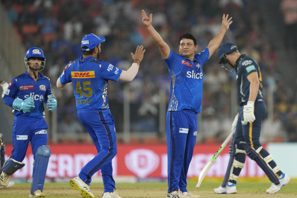 Mumbai Indian's Piyush Chawla, second right, celebrates with teammates the dismissal of Gujarat Titan's Vijay Shankar during Indian Premier League (IPL) cricket match between Mumbai Indians and Gujarat Titans, in Ahmedabad, India, Tuesday, April 25, 2023.(AP Photo/Ajit Solanki)